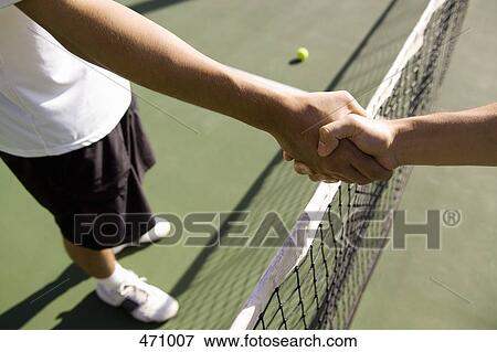 Two tennis players shake hands across the net View Large Photo Image Stock Photo - Two tennis players shake hands across the net. Fotosearch