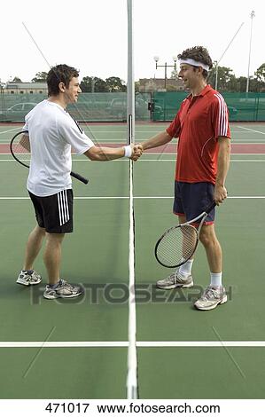 Two tennis players shaking hands across the net View Large Photo Image Stock Photo - Two tennis players shaking hands across the net. Fotosearch