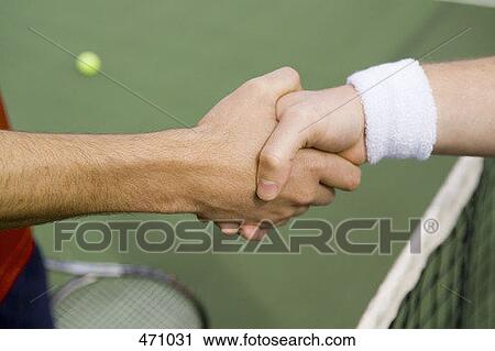 Stock Image - Two tennis players shaking hands. Fotosearch