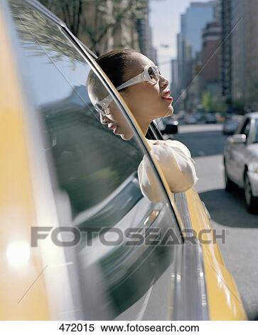 A woman leaning out of a taxi window, New York City, USA View Large Photo Image Stock Photography - A woman leaning out of a taxi window, New York City, USA. Fotosearch
