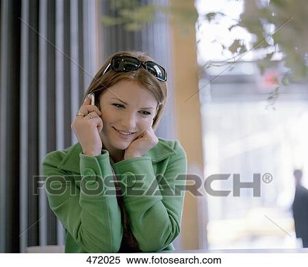 A woman using a mobile phone View Large Photo Image Stock Photography - A woman using a mobile phone. Fotosearch