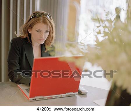 Woman working on a laptop computer View Large Photo Image Stock Photography - Woman working on a laptop computer. Fotosearch
