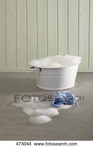 Picture - A bucket of soapy water and a cloth on the floor. Fotosearch