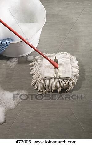 Stock Photograph - A bucket of soapy water and a mop. Fotosearch