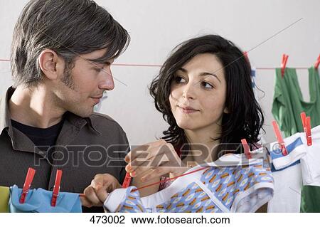 Stock Image - A couple hanging washing out together. Fotosearch