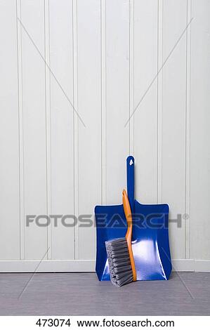 Picture - A dustpan and broom in a corner. Fotosearch