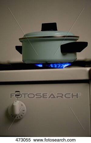 Stock Photography - A saucepan on a lit stove. Fotosearch