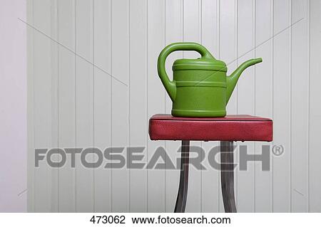 A watering can on a stool View Large Photo Image Stock Image - A watering can on a stool. Fotosearch