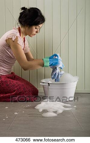 A woman cleaning the floor View Large Photo Image Stock Photograph - A woman cleaning the floor. Fotosearch