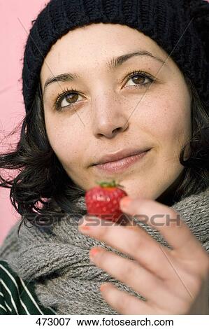 A woman holding a strawberry View Large Photo Image Stock Photo - A woman holding a strawberry. Fotosearch
