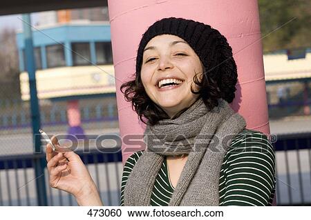 Stock Image - A woman smoking a cigarette. Fotosearch