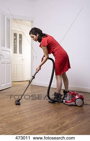 A woman vacuuming View Large Photo Image Stock Image - A woman vacuuming. Fotosearch