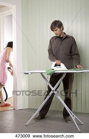 A young couple doing housework View Large Photo Image Stock Photo - A young couple doing housework. Fotosearch