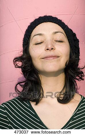 Stock Photo - A young woman with eyes closed. Fotosearch