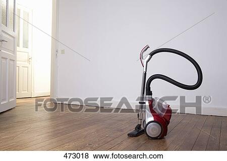 Vacuum cleaner in an empty room View Large Photo Image Stock Photo - Vacuum cleaner in an empty room. Fotosearch