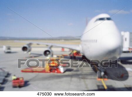 An airplane being refueled at an airport View Large Photo Image Stock Image - An airplane being refueled at an airport. Fotosearch