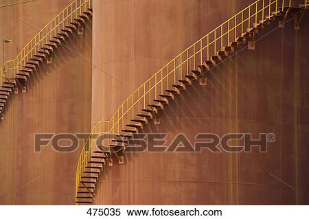 Detail of stairs curving around large storage tanks View Large Photo Image Stock Photography - Detail of stairs curving around large storage tanks. Fotosearch
