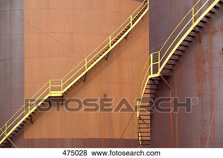 Stock Photo - Detail of stairs on large storage tanks. Fotosearch