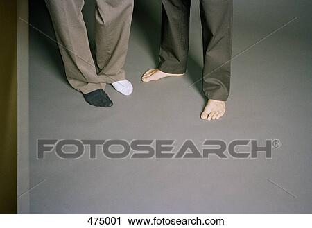Low section of two men standing barefoot View Large Photo Image Stock Image - Low section of two men standing barefoot. Fotosearch