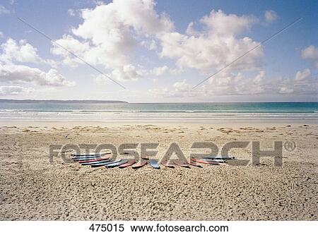 Surfboards in a row on a beach View Large Photo Image Stock Photography - Surfboards in a row on a beach. Fotosearch