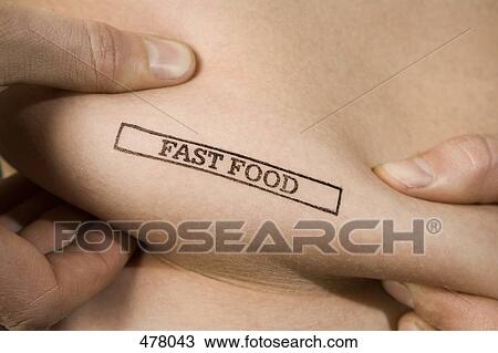 A man pinching part of his abdomen stamped 'Fast Food' View Large Photo Image Stock Image - A man pinching part of his abdomen stamped 'Fast Food'. Fotosearch
