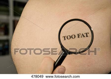 Stock Photo - A person holding a magnifying glass to a man's abdomen stamped 'Too Fat'. Fotosearch