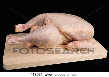 A raw chicken on a wooden cutting board View Large Photo Image Stock Image - A raw chicken on a wooden cutting board. Fotosearch