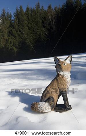An imitation fox sitting in the snow View Large Photo Image Stock Image - An imitation fox sitting in the snow. Fotosearch