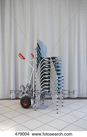 Picture - Stacked chairs on a sack barrow. Fotosearch