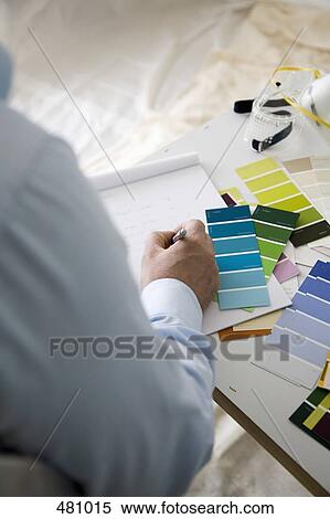 A man sitting at a table with color samples View Large Photo Image Stock Photography - A man sitting at a table with color samples. Fotosearch