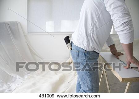 A man standing next to a decorating table View Large Photo Image Stock Photo - A man standing next to a decorating table. Fotosearch
