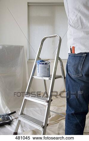 A man standing next to decorating equipment View Large Photo Image Stock Photography - A man standing next to decorating equipment. Fotosearch