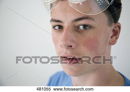 A teenage boy wearing safety glasses View Large Photo Image Stock Photography - A teenage boy wearing safety glasses. Fotosearch