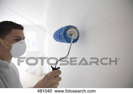 Teenage boy painting a wall View Large Photo Image Stock Image - Teenage boy painting a wall. Fotosearch