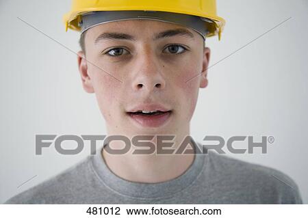 Teenage boy wearing a hard hat View Large Photo Image Stock Image - Teenage boy wearing a hard hat. Fotosearch