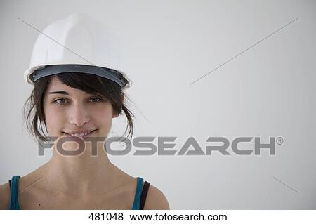 Teenage girl wearing a hardhat View Large Photo Image Stock Photo - Teenage girl wearing a hardhat. Fotosearch