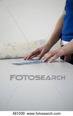 Stock Photo - Woman comparing color samples. Fotosearch