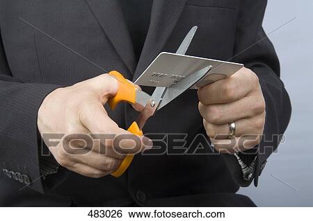A businessman cutting up a credit card View Large Photo Image Stock Photograph - A businessman cutting up a credit card. Fotosearch