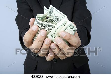 A businessman with a handful of US bank notes View Large Photo Image Stock Image - A businessman with a handful of US bank notes. Fotosearch