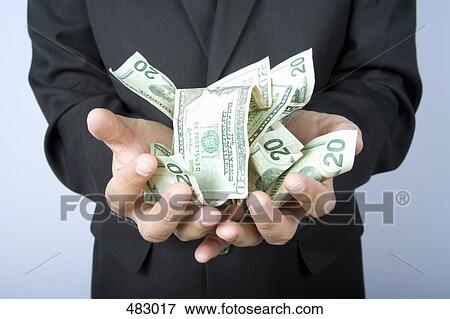 A businessman with a handful of US bank notes View Large Photo Image Stock Photo - A businessman with a handful of US bank notes. Fotosearch