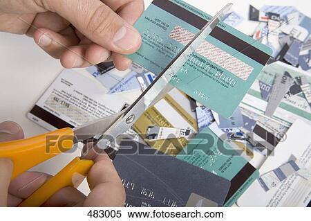 A man cutting up credit cards View Large Photo Image Stock Photography - A man cutting up credit cards. Fotosearch