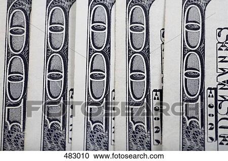 Stock Image - Detail of hundred dollar bills in a row. Fotosearch