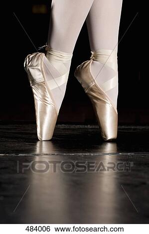 A ballerina balancing on her tiptoes View Large Photo Image Stock Photograph - A ballerina balancing on her tiptoes. Fotosearch
