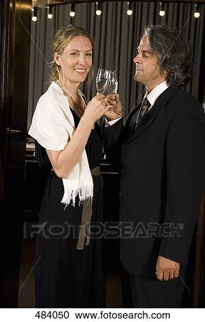 A couple toasting with champagne at a theater View Large Photo Image Stock Image - A couple toasting with champagne at a theater. Fotosearch