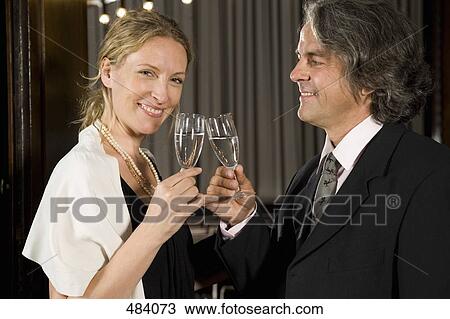 A couple toasting with champagne at a theater View Large Photo Image Stock Image - A couple toasting with champagne at a theater. Fotosearch