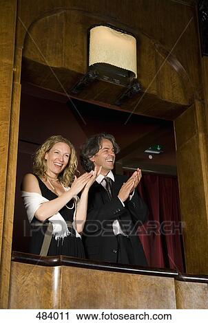 A couple using binoculars in a theater box View Large Photo Image Stock Image - A couple using binoculars in a theater box. Fotosearch