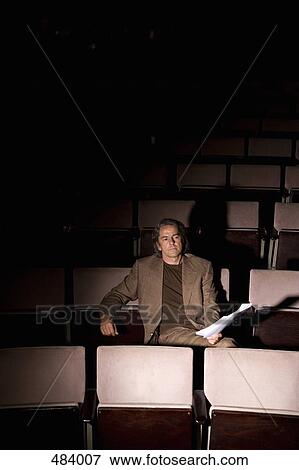 A director sitting in a theater View Large Photo Image Stock Photo - A director sitting in a theater. Fotosearch