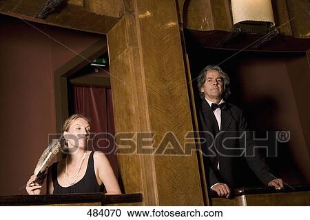 A man and a woman in separate theater boxes View Large Photo Image Stock Image - A man and a woman in separate theater boxes. Fotosearch