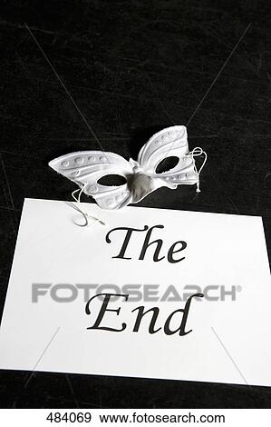 Stock Photo - A mask and a sign for 'The End' on a theater stage. Fotosearch