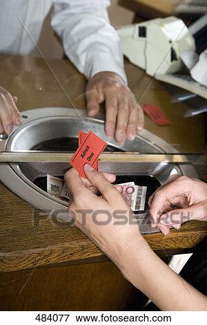 A person buying tickets at a box office View Large Photo Image Stock Photo - A person buying tickets at a box office. Fotosearch